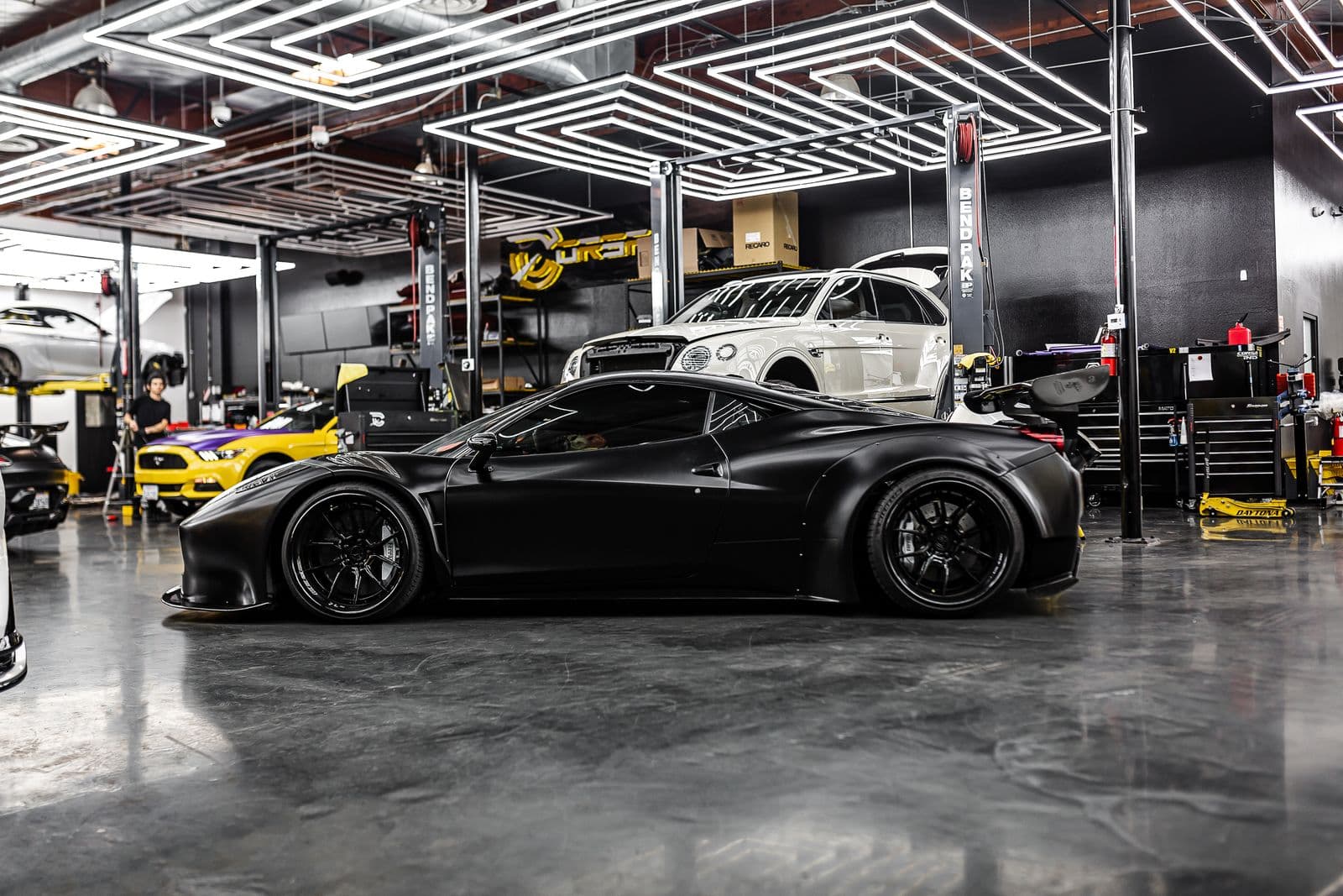 Mirror-gloss coated floor reflecting a collector car — the finish class a Weston cost quote covers