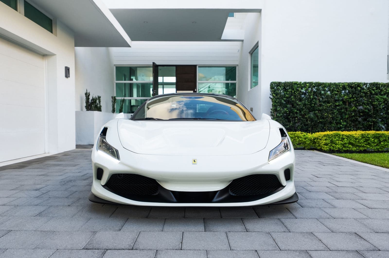 Sports car on the paver drive of a modern estate home with a wide garage — Weston-style housing stock
